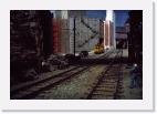 s2_028_CERR_jun65 * The gent on the left snapping his suspenders has a swipe of the late Abe Lincoln in him as he relaxes under a bridge at Great Divide. The CERR Trolley heads down Railroad Avenue towards the Port station. 6-65 * 4272 x 2888 * (3.16MB)